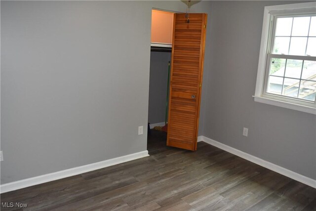 1408 N 9th St, Martins Ferry, OH 43935 - unfurnished bedroom with baseboards, dark wood-style flooring, and a closet