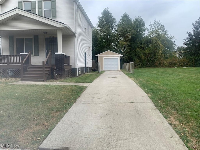 3961 E 53rd St, Newburgh Heights, OH 44105 - view of side of home with covered porch, an outbuilding, a lawn, driveway, and a garage