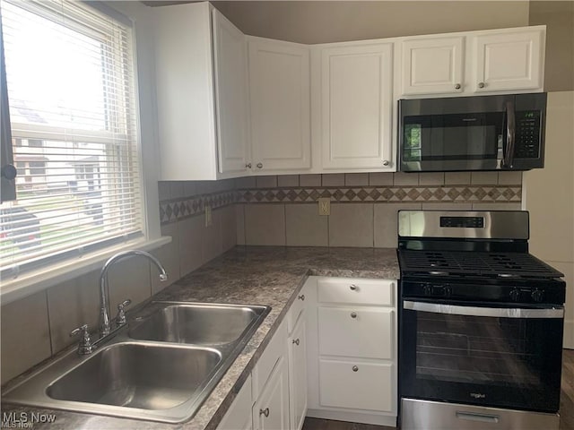 3961 E 53rd St, Newburgh Heights, OH 44105 - kitchen featuring gas stove, a sink, healthy amount of natural light, and tasteful backsplash