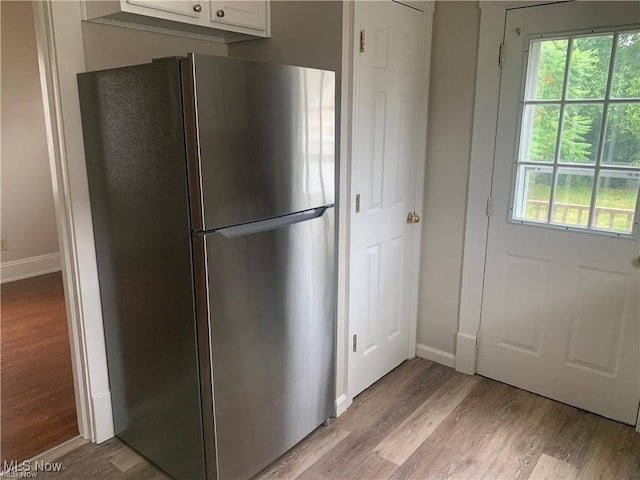 3961 E 53rd St, Newburgh Heights, OH 44105 - kitchen with freestanding refrigerator, light wood-type flooring, healthy amount of natural light, and baseboards