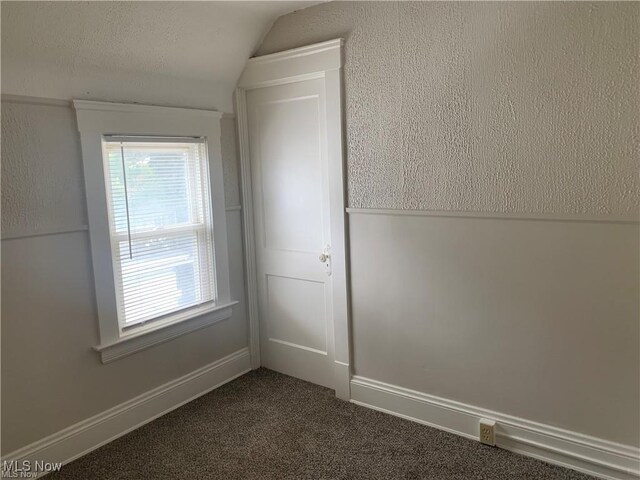 3961 E 53rd St, Newburgh Heights, OH 44105 - unfurnished room with vaulted ceiling and dark colored carpet
