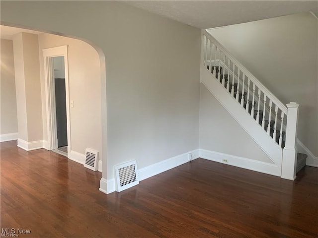 3961 E 53rd St, Newburgh Heights, OH 44105 - spare room featuring wood finished floors, baseboards, arched walkways, and stairs