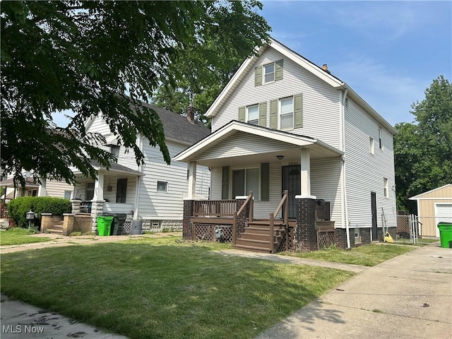 3961 E 53rd St, Newburgh Heights, OH 44105 - american foursquare style home with a porch and a gate