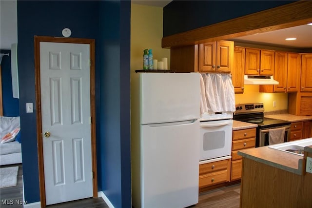 1553 Quail Hollow Dr, Cambridge, OH 43725 - kitchen featuring white appliances, under cabinet range hood, dark wood finished floors, light countertops, and brown cabinets