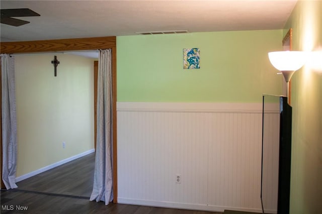 1553 Quail Hollow Dr, Cambridge, OH 43725 - spare room with a wainscoted wall, wood finished floors, and a ceiling fan