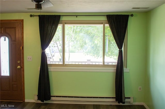 1553 Quail Hollow Dr, Cambridge, OH 43725 - foyer entrance featuring a baseboard heating unit and wood finished floors