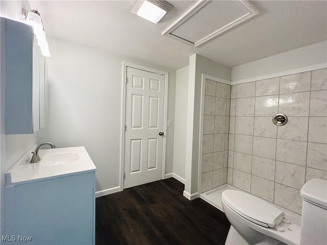 2815 Race Track Rd, New Cumberland, WV 26047 - bathroom with toilet, vanity, tiled shower, wood finished floors, and baseboards