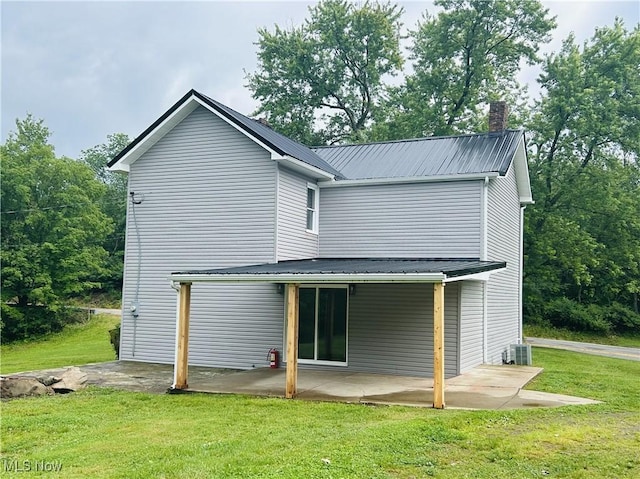 2815 Race Track Rd, New Cumberland, WV 26047 - back of house featuring metal roof, a lawn, and a patio area