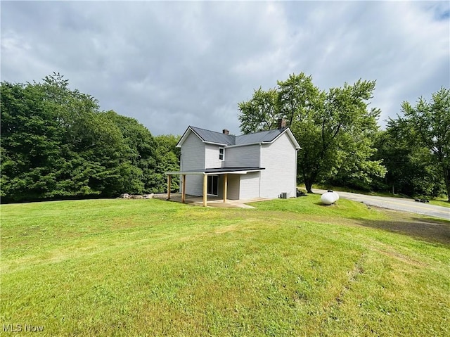 2815 Race Track Rd, New Cumberland, WV 26047 - back of property with a chimney, a lawn, and metal roof