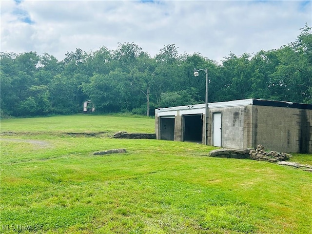 2815 Race Track Rd, New Cumberland, WV 26047 - view of grassy yard with an outdoor structure, a detached garage, and a forest view