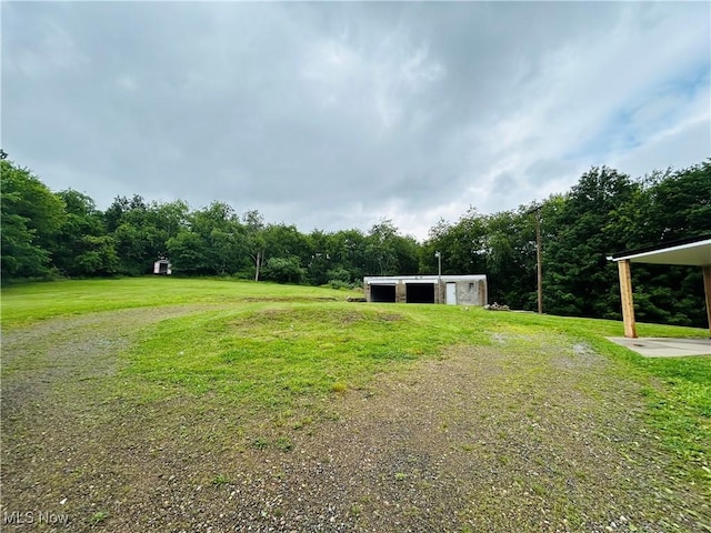 2815 Race Track Rd, New Cumberland, WV 26047 - view of grassy yard with a pole building, an outbuilding, and a wooded view