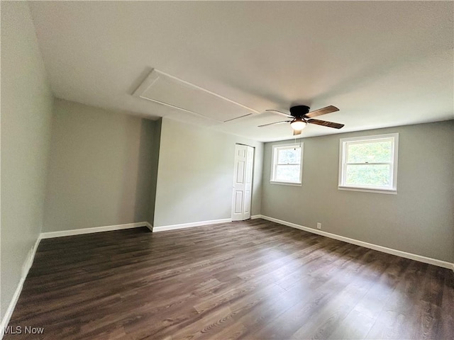 2815 Race Track Rd, New Cumberland, WV 26047 - empty room with attic access, dark wood-style flooring, baseboards, and ceiling fan