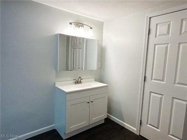 2815 Race Track Rd, New Cumberland, WV 26047 - bathroom with baseboards, vanity, and wood finished floors