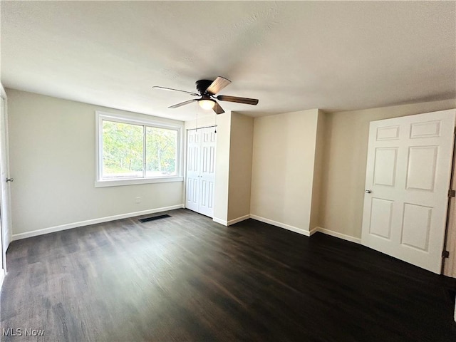 2815 Race Track Rd, New Cumberland, WV 26047 - unfurnished bedroom with dark wood-style floors, baseboards, ceiling fan, and a closet