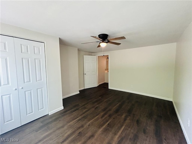2815 Race Track Rd, New Cumberland, WV 26047 - unfurnished bedroom featuring dark wood-type flooring, baseboards, a closet, and ceiling fan