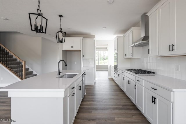 3730 Overlook Ct, Akron, OH 44333 - kitchen featuring wall chimney exhaust hood, stainless steel appliances, dark wood finished floors, tasteful backsplash, and white cabinetry