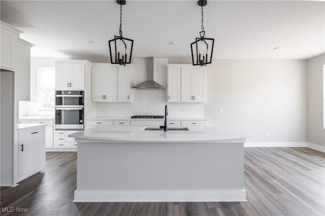 3730 Overlook Ct, Akron, OH 44333 - kitchen with wall chimney range hood, double oven, light countertops, and backsplash