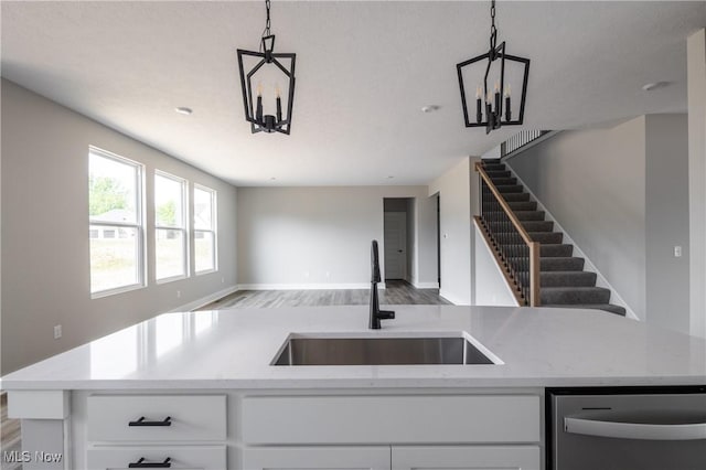 3730 Overlook Ct, Akron, OH 44333 - kitchen with dishwasher, open floor plan, wood finished floors, a chandelier, and light stone countertops