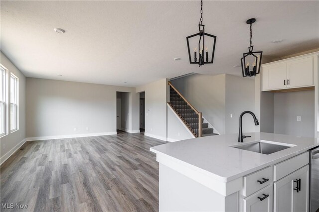 3730 Overlook Ct, Akron, OH 44333 - kitchen featuring hanging light fixtures, light wood-type flooring, dishwasher, light countertops, and white cabinetry
