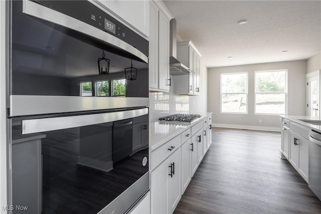 3730 Overlook Ct, Akron, OH 44333 - kitchen with appliances with stainless steel finishes, dark wood-type flooring, white cabinetry, light countertops, and tasteful backsplash