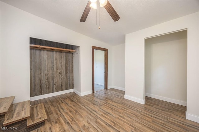 15295 State Route 60, Lowell, OH 45744 - unfurnished bedroom featuring wood finished floors, baseboards, a closet, a ceiling fan, and vaulted ceiling
