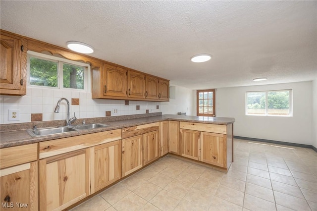15295 State Route 60, Lowell, OH 45744 - kitchen with a sink, a peninsula, light tile patterned flooring, a textured ceiling, and dark countertops
