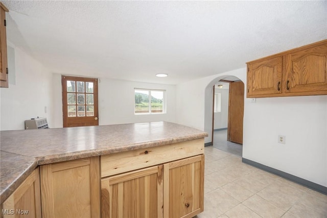 15295 State Route 60, Lowell, OH 45744 - kitchen with arched walkways, light tile patterned flooring, baseboards, and a peninsula