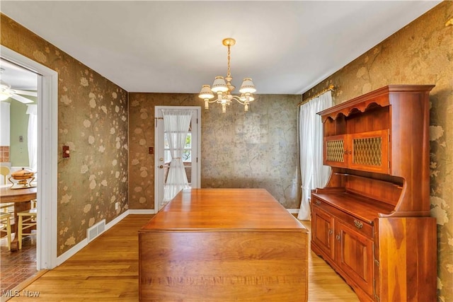1783 Maywood Rd, South Euclid, OH 44121 - dining area featuring a chandelier, light wood-style floors, wallpapered walls, and a ceiling fan