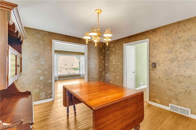 1783 Maywood Rd, South Euclid, OH 44121 - dining room with wood finished floors, a chandelier, baseboards, and wallpapered walls