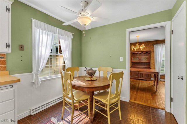 1783 Maywood Rd, South Euclid, OH 44121 - dining room featuring plenty of natural light, brick patterned flooring, a ceiling fan, and a chandelier