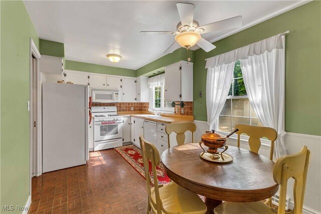 1783 Maywood Rd, South Euclid, OH 44121 - kitchen with white appliances, light countertops, white cabinets, decorative backsplash, and a sink