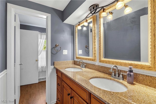 1783 Maywood Rd, South Euclid, OH 44121 - bathroom featuring double vanity, wood finished floors, and a wainscoted wall