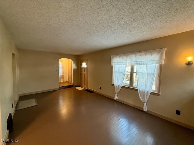 3427 Elm St, Weirton, WV 26062 - unfurnished room featuring arched walkways and a textured ceiling
