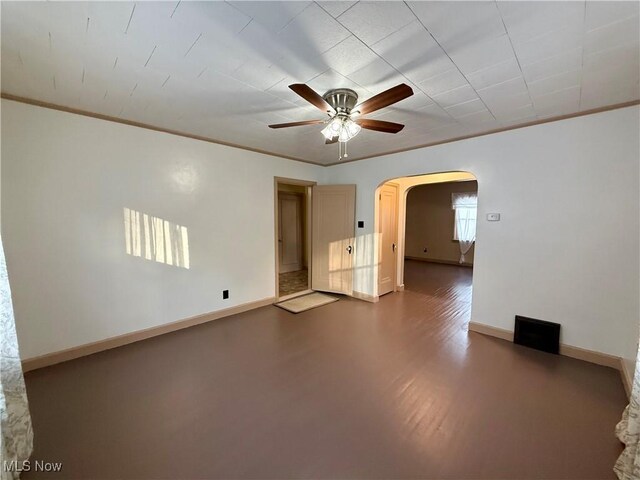 3427 Elm St, Weirton, WV 26062 - spare room featuring a ceiling fan, arched walkways, dark wood-type flooring, and crown molding