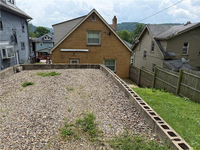 3427 Elm St, Weirton, WV 26062 - rear view of house with a chimney, a fenced backyard, and brick siding