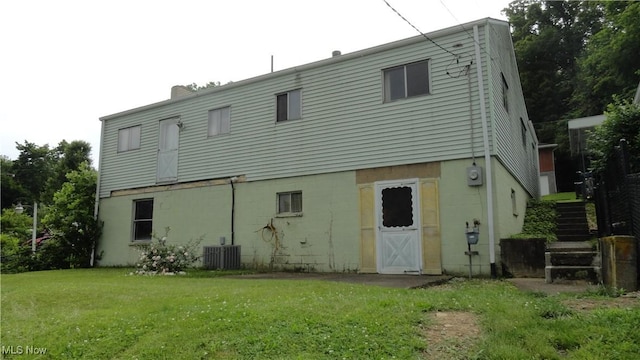 521 Georgia Ave, Chester, WV 26034 - rear view of house with a lawn, stairway, central AC, and a chimney