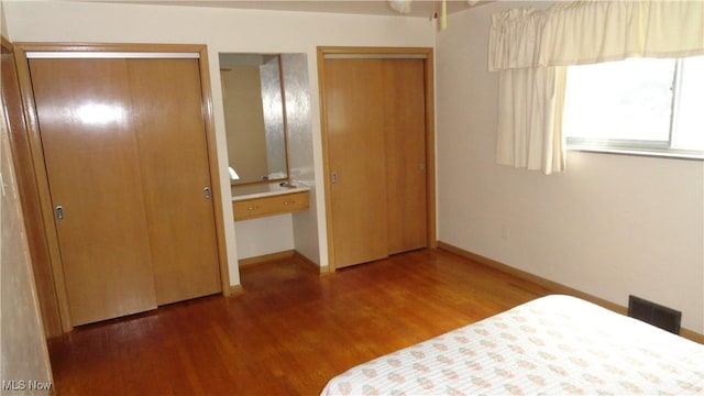 521 Georgia Ave, Chester, WV 26034 - bedroom with two closets, wood finished floors, and baseboards