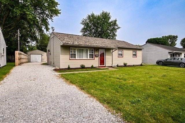 2312 Midway Ave NE, Canton, OH 44705 - ranch-style home featuring gravel driveway, a front lawn, an outdoor structure, and a detached garage