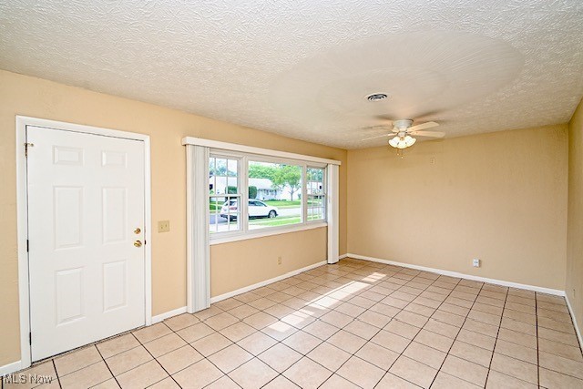 2312 Midway Ave NE, Canton, OH 44705 - foyer entrance with a ceiling fan, light tile patterned floors, baseboards, and a textured ceiling