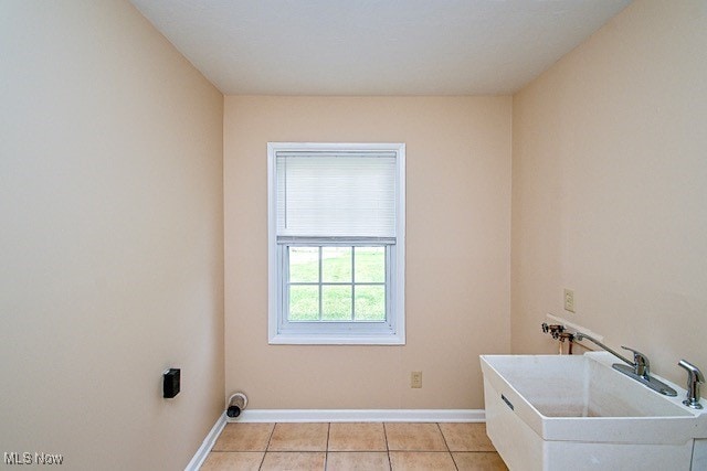 2312 Midway Ave NE, Canton, OH 44705 - laundry area with light tile patterned floors, washer hookup, and baseboards