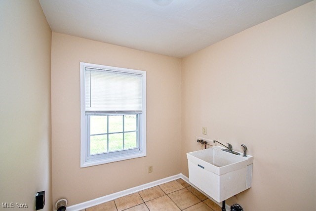 2312 Midway Ave NE, Canton, OH 44705 - laundry area featuring hookup for a washing machine, light tile patterned flooring, and baseboards