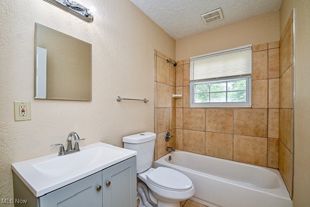2312 Midway Ave NE, Canton, OH 44705 - bathroom with toilet, vanity,  shower combination, a textured ceiling, and a textured wall