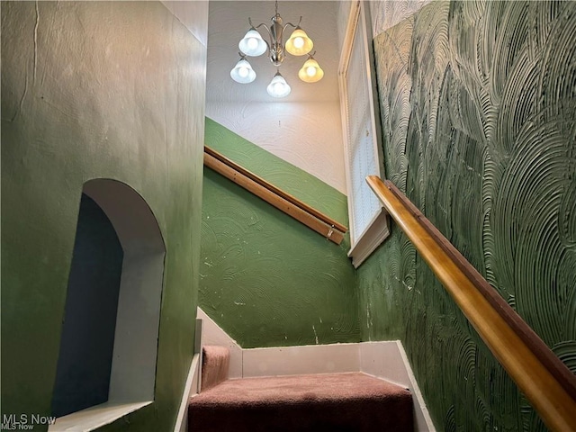 615 Noah Ave, Akron, OH 44320 - stairs with a chandelier and arched walkways