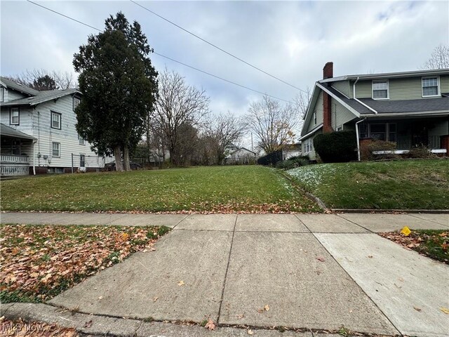 615 Noah Ave, Akron, OH 44320 - view of home's exterior with a chimney and a yard