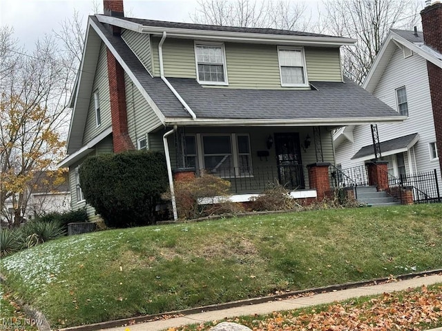615 Noah Ave, Akron, OH 44320 - view of front of property with a chimney, roof with shingles, a front lawn, and covered porch