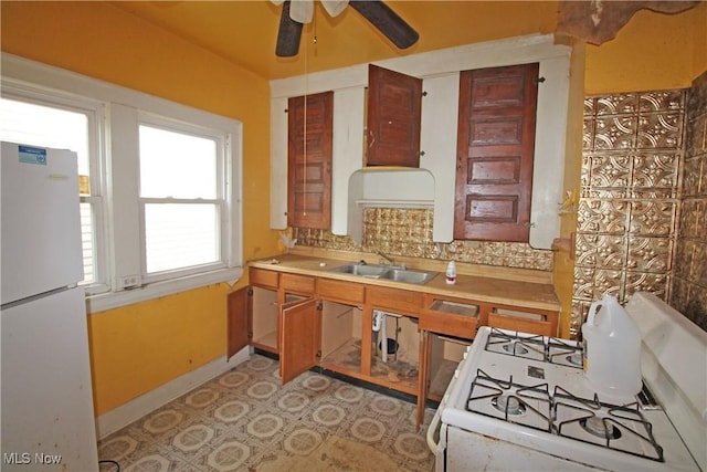 4076 E 106th St, Cleveland, OH 44105 - kitchen featuring white appliances, a sink, a ceiling fan, light countertops, and decorative backsplash