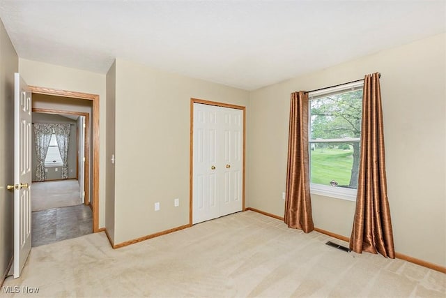 3840 Dartford Ln, Medina, OH 44256 - unfurnished bedroom featuring light colored carpet, baseboards, and a closet