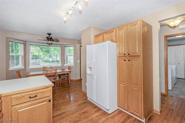 3840 Dartford Ln, Medina, OH 44256 - kitchen with white fridge with ice dispenser, washer and clothes dryer, light wood-style flooring, ceiling fan, and light brown cabinets