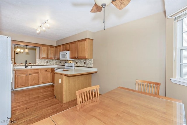 3840 Dartford Ln, Medina, OH 44256 - kitchen featuring white appliances, a sink, ceiling fan, a peninsula, and light countertops