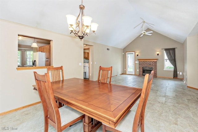 3840 Dartford Ln, Medina, OH 44256 - dining room with plenty of natural light, ceiling fan, a chandelier, a brick fireplace, and high vaulted ceiling